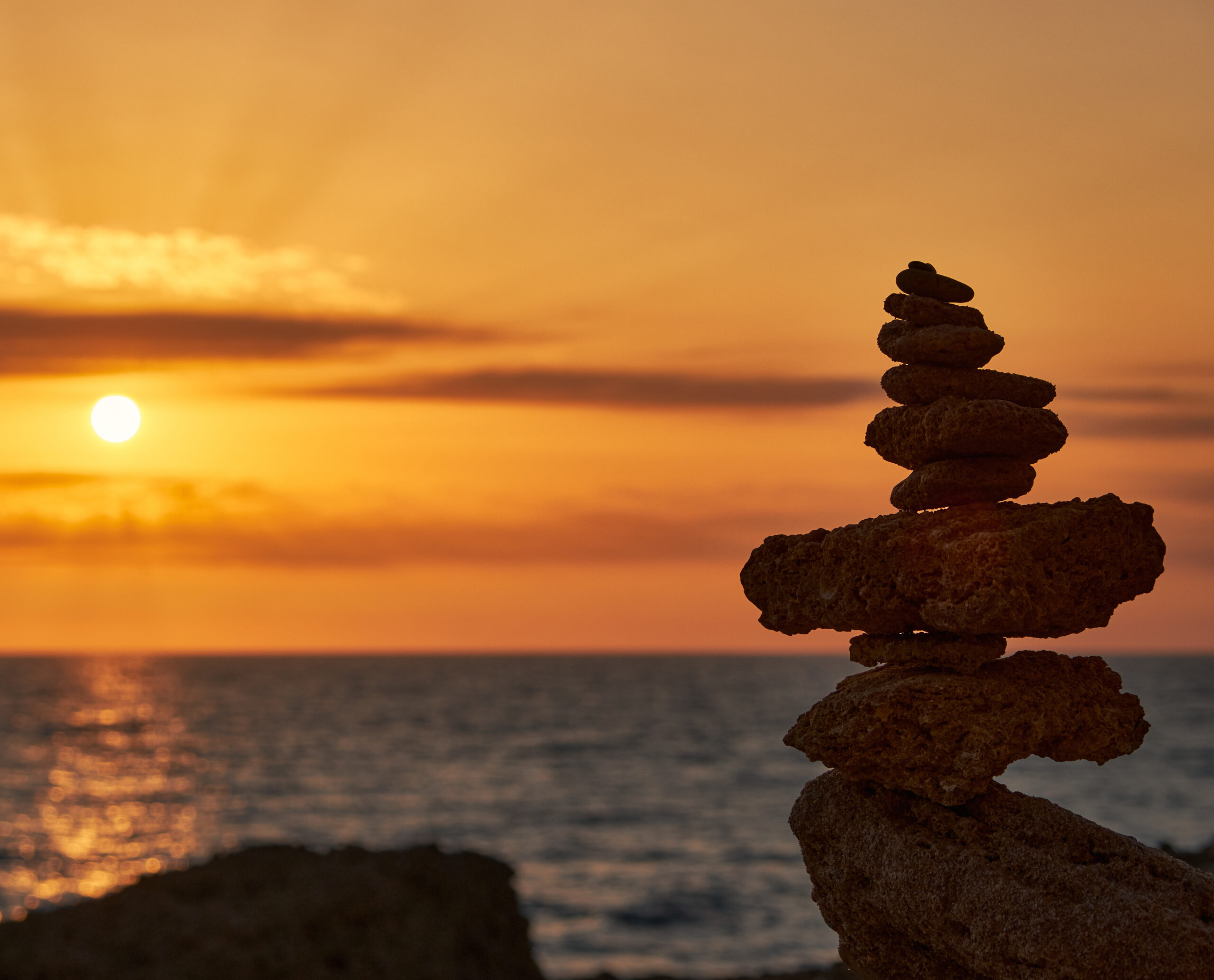 Stack Of Rocks Against A Beautiful Sunset At Roche Cove In Conil De La Frontera, Spain
